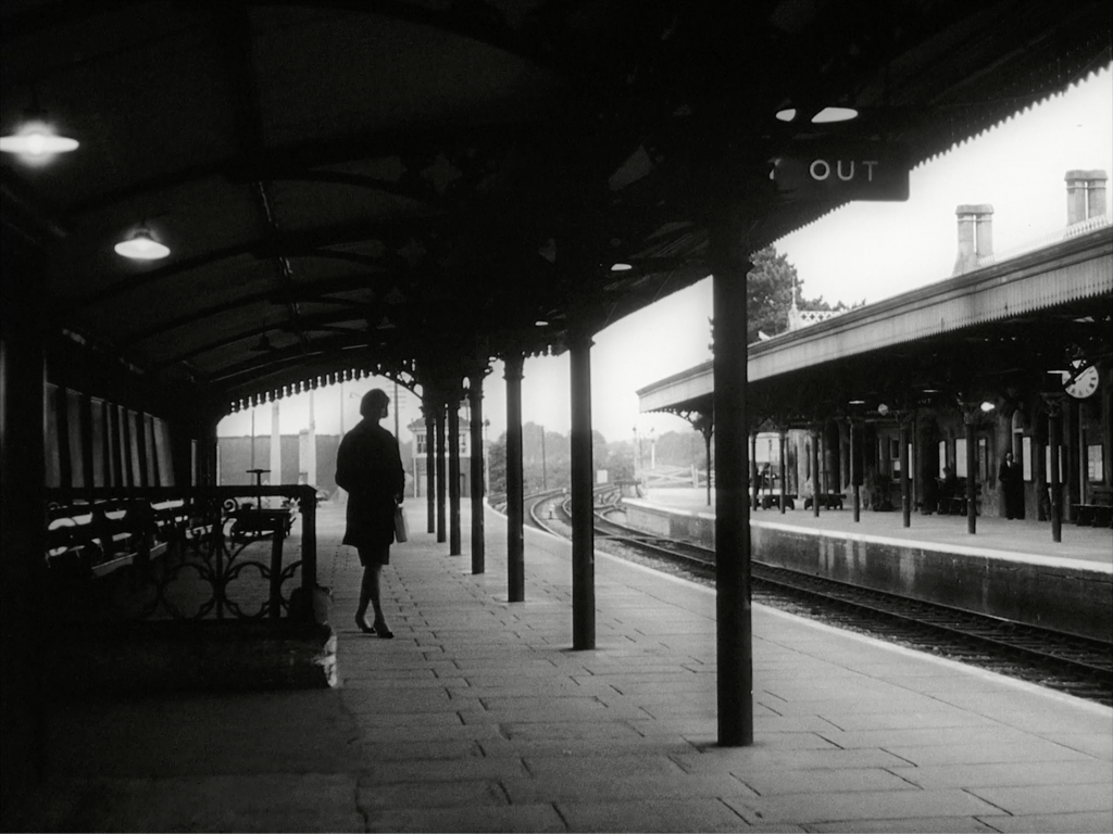 Woman on lonely train platform 